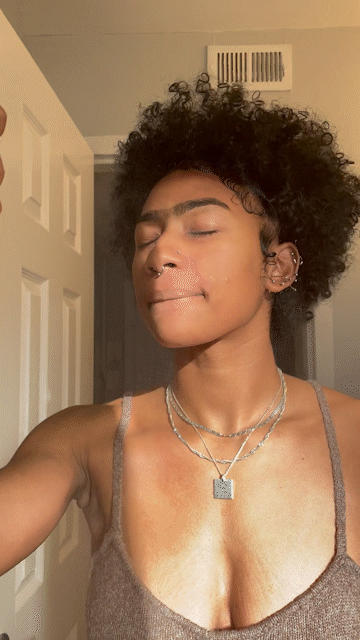 Female model sprays the Rose Water on to her skin