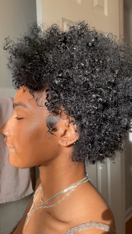 Gif of a female model spinning around showcasing her beautiful  afro