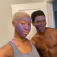 A female and male model couple have the Noor Lavender Mask on their faces 