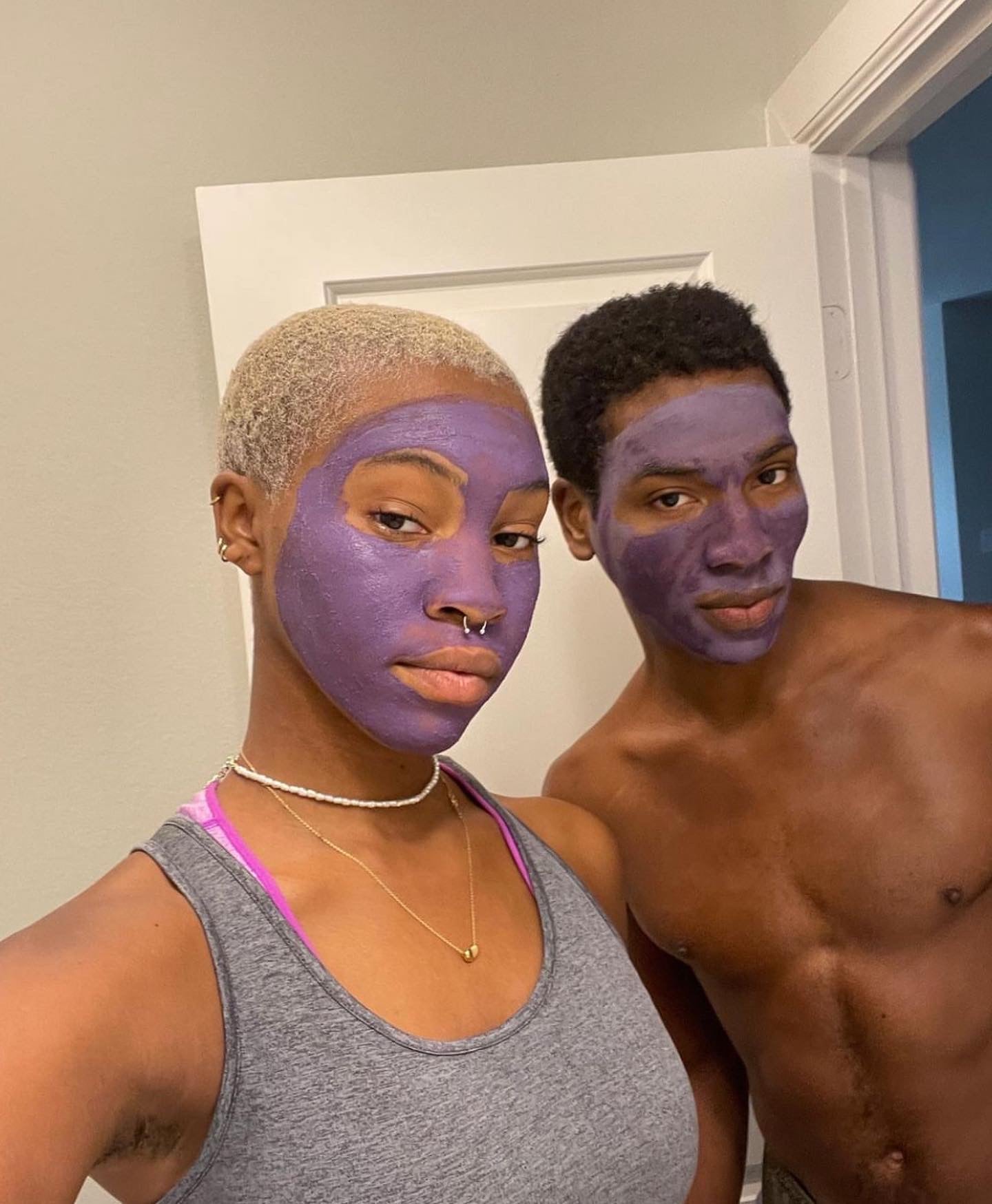 A female and male model couple have the Noor Lavender Mask on their faces 